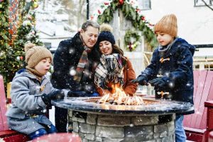 A family enjoying a patio together outdoor during the winter.