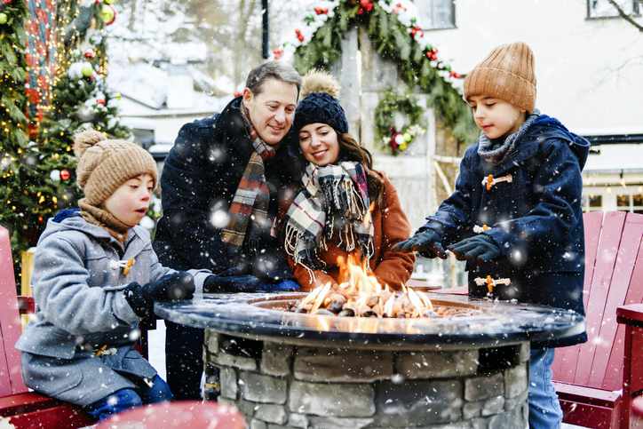 A family enjoying a patio together outdoor during the winter.