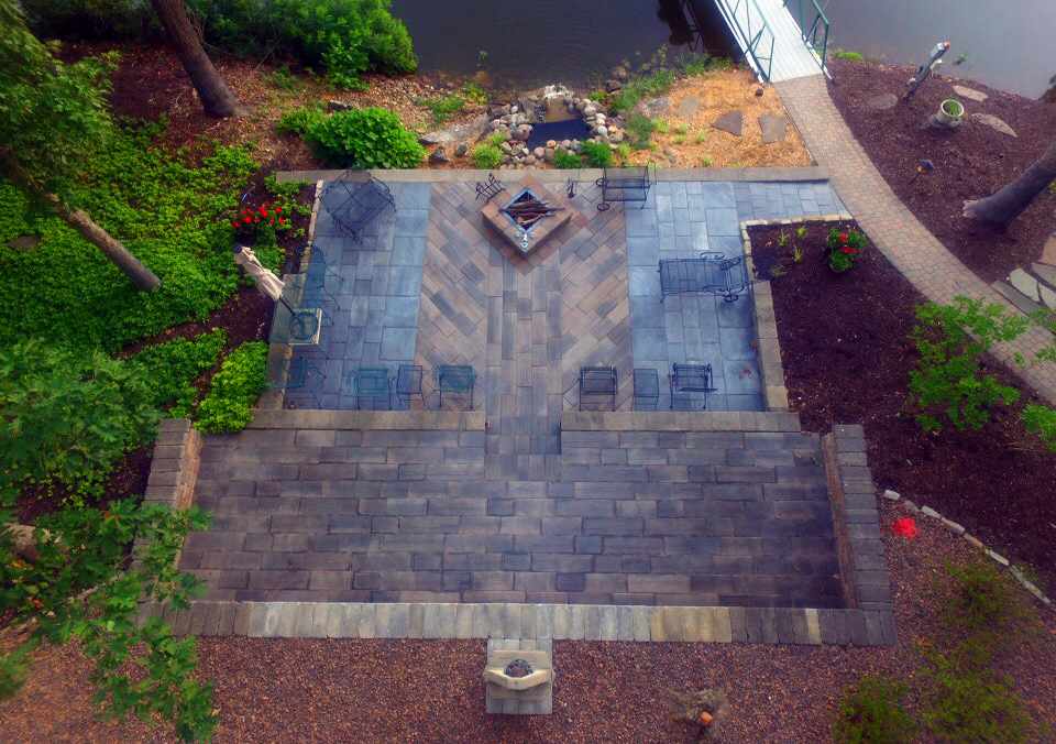 Patio designed with stone landscape pavers in an attractive pattern.