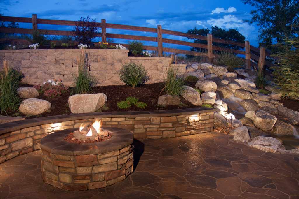 Beautiful Backyard Fire Pit and Seat Wall on flagstone patio