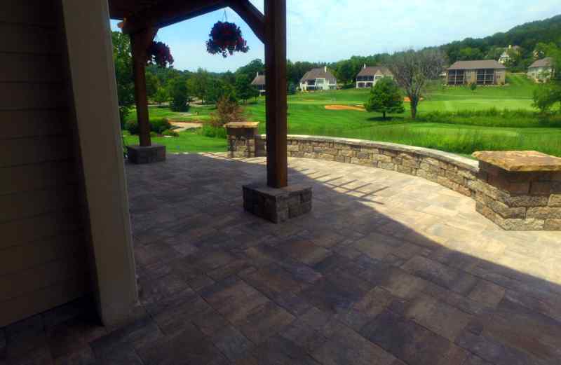 Stone patio overlooking lush green grass.