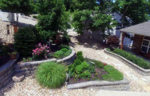 Hilly front yard at Lake of the Ozarks with multiple retaining walls.