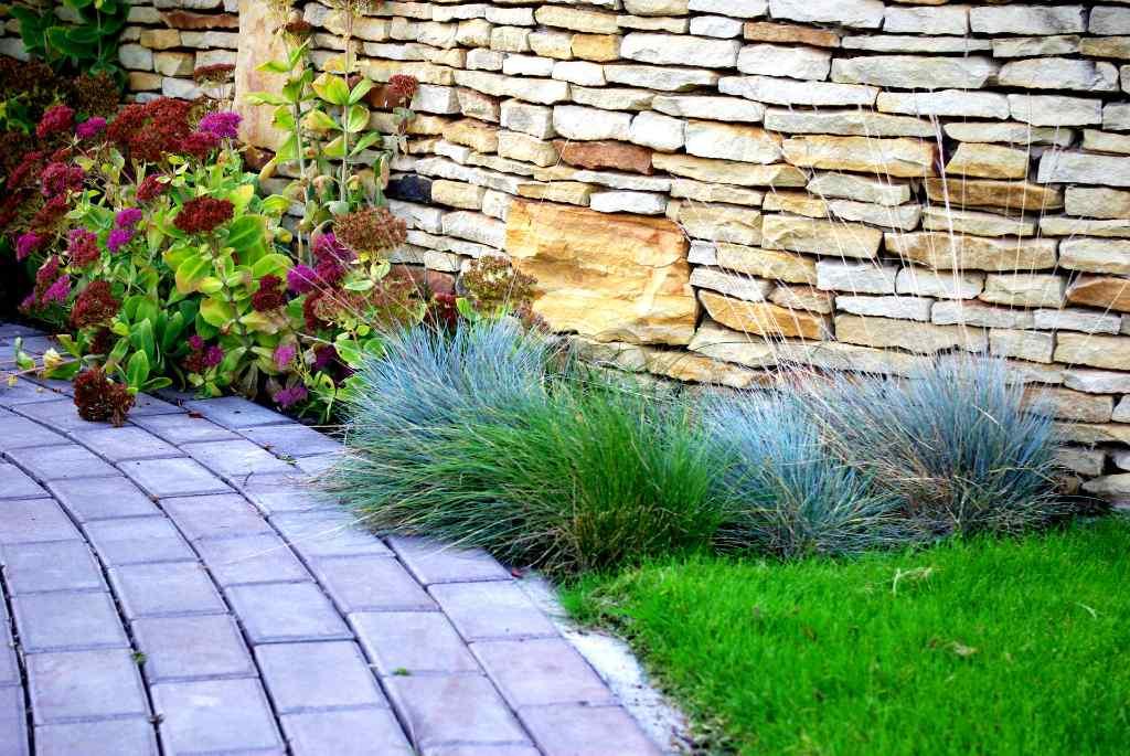 A path by a garden wall built with outdoor project stone materials