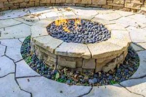 Nice Belvedere Fire Pit Kit with a fire burning, set on a stone paver patio