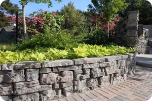 Belvedere Coping capping a raised bed retaining wall with flowers and plants in it