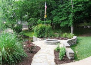 A stone firepit on a flagstone patio at Lake of the Ozarks.